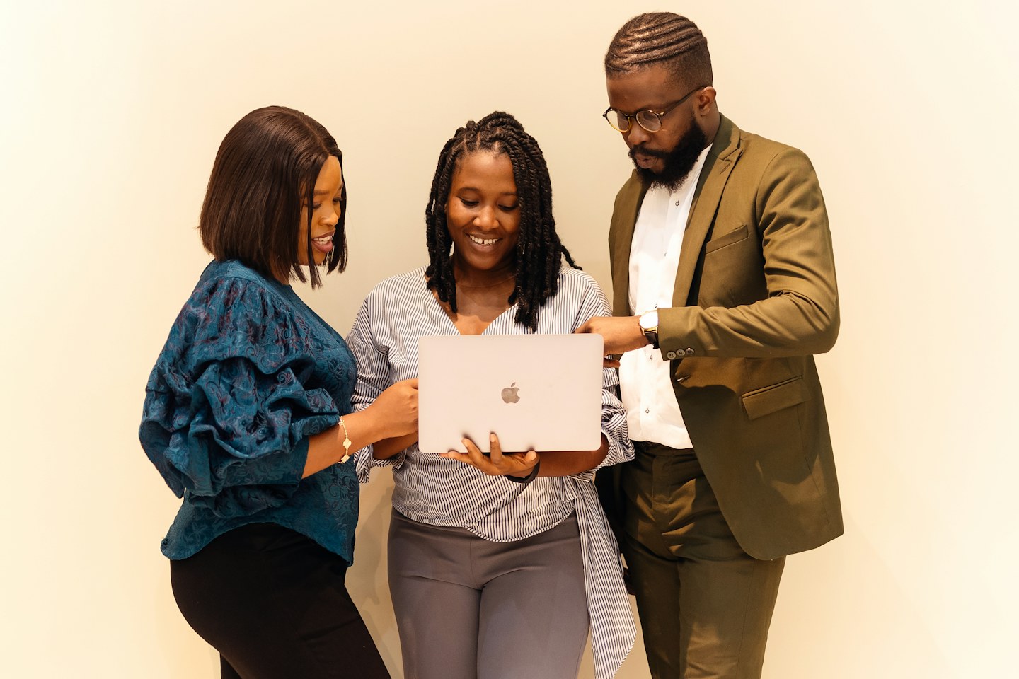 Three young professionals working together with a laptop in Lagos