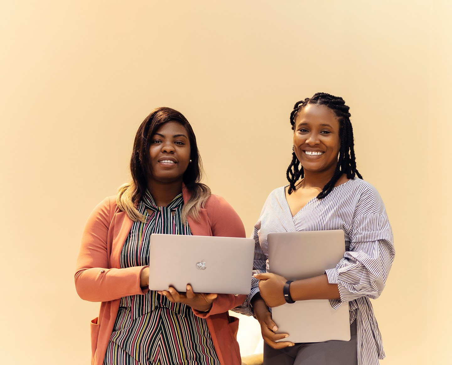 Two women using laptops together in Lagos